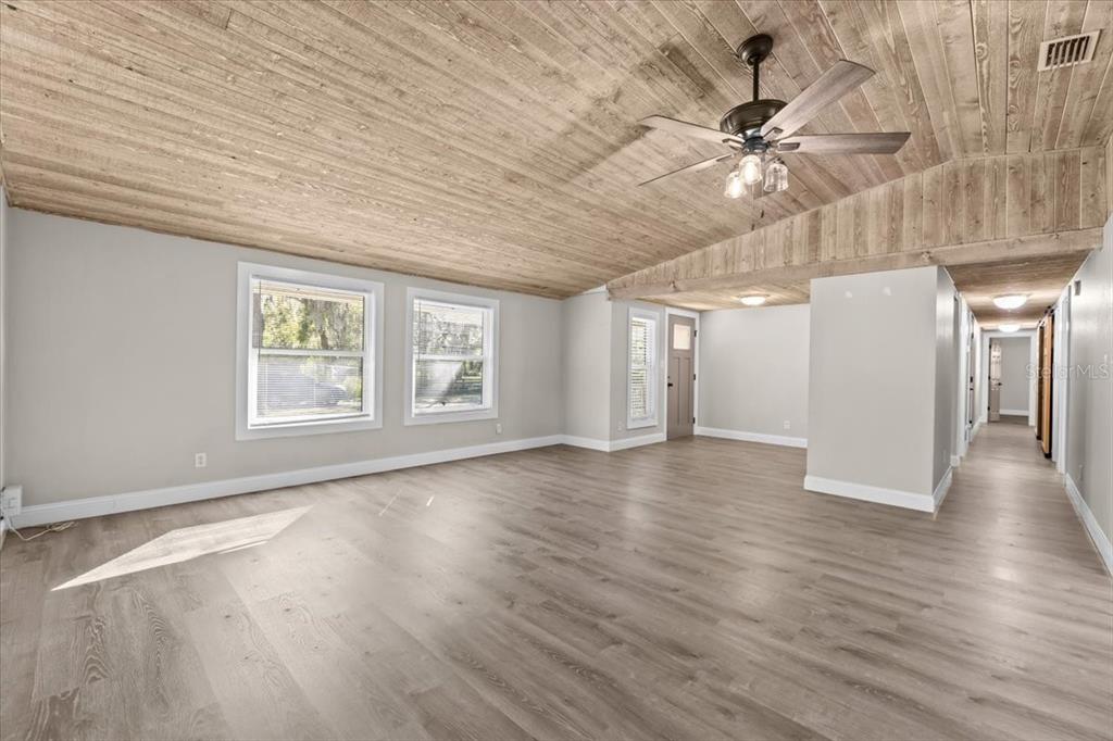 4805 Cooper Road Plant City, FL 33565 - Photo 36 of 45 an empty room with wooden floor fan and windows