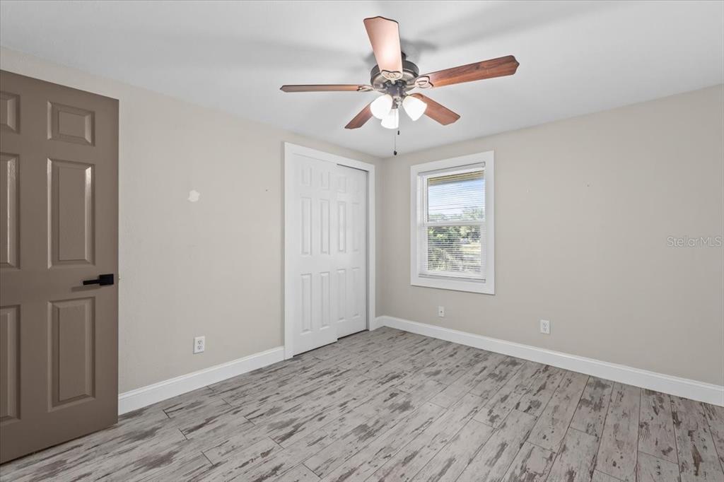 4805 Cooper Road Plant City, FL 33565 - Photo 9 of 45 a view of an empty room with wooden floor and a window