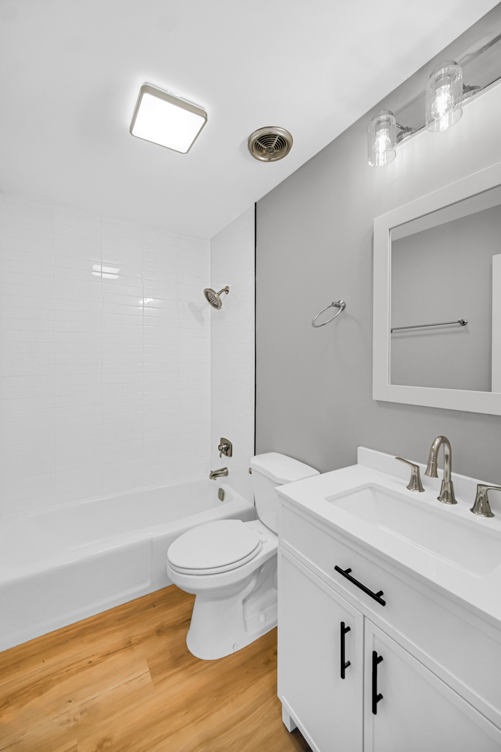 6827 Sussex Road Tinley Park, IL 60477 - Photo 12 of 27 a bathroom with a sink toilet and a mirror