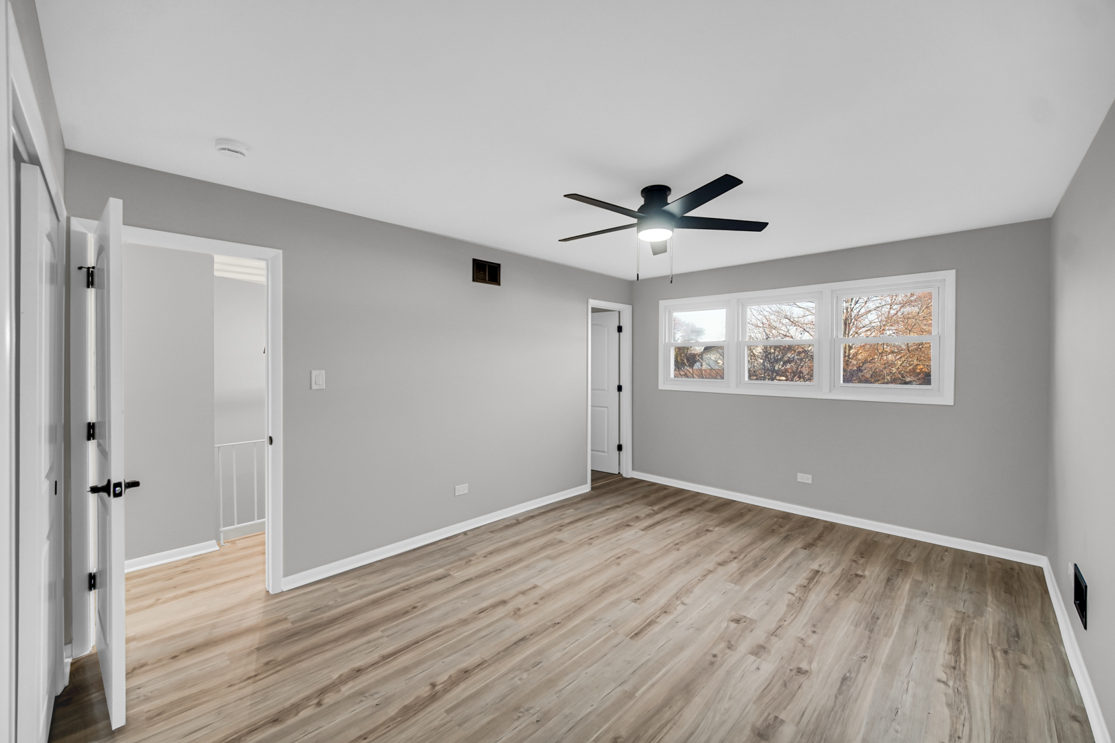 6827 Sussex Road Tinley Park, IL 60477 - Photo 14 of 27 a view of empty room with wooden floor and fan