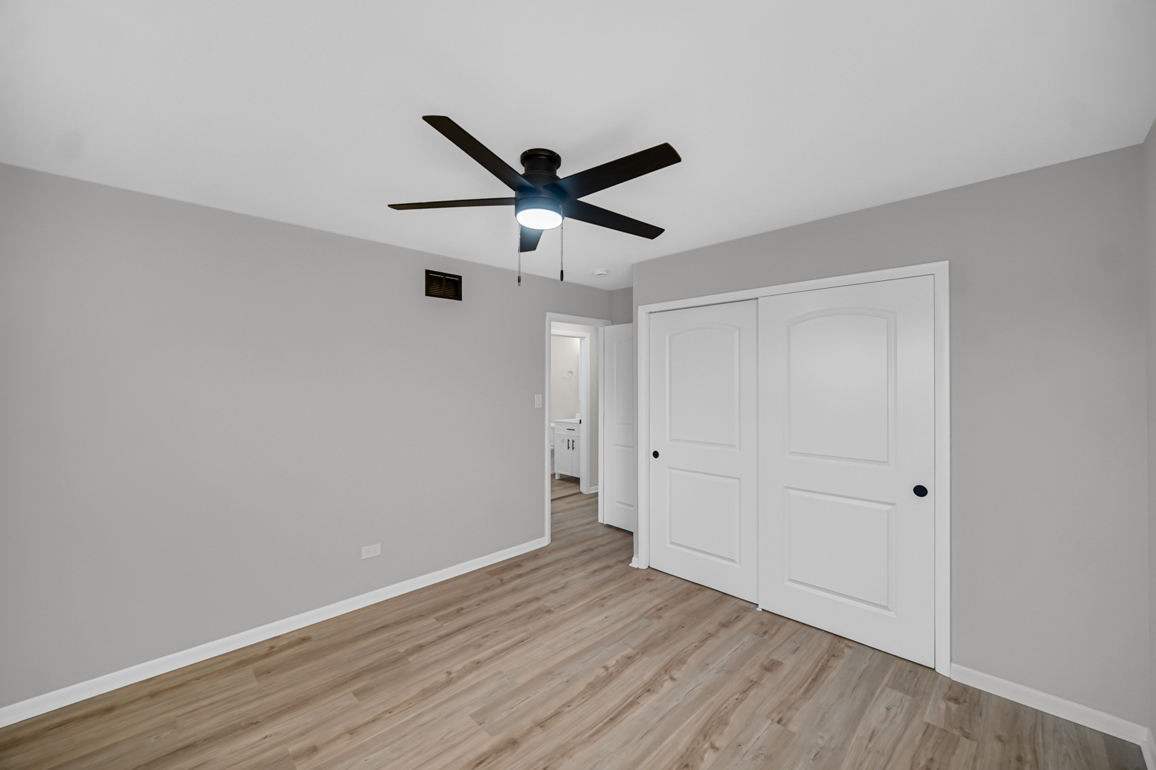 6827 Sussex Road Tinley Park, IL 60477 - Photo 18 of 27 a view of an empty room with wooden floor