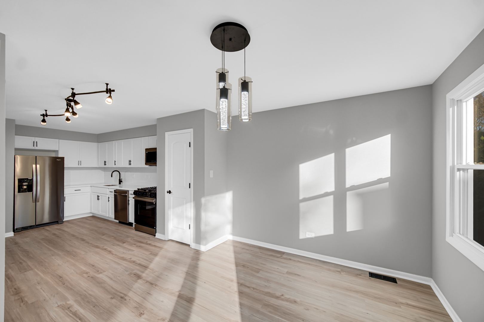 6827 Sussex Road Tinley Park, IL 60477 - Photo 4 of 27 a view of a kitchen with a sink and dishwasher wooden floor