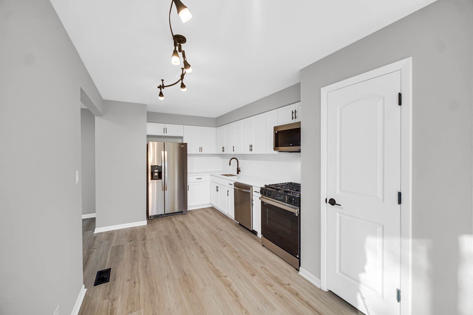 6827 Sussex Road Tinley Park, IL 60477 - Photo 5 of 27 a kitchen with stainless steel appliances granite countertop a refrigerator and a stove top oven