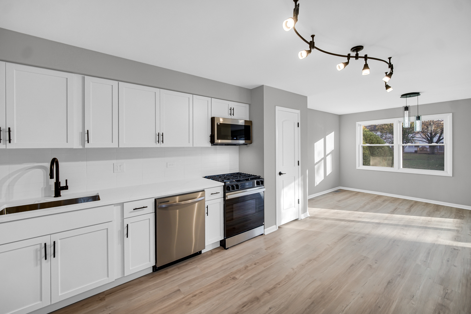6827 Sussex Road Tinley Park, IL 60477 - Photo 6 of 27 a kitchen with a sink stove and refrigerator