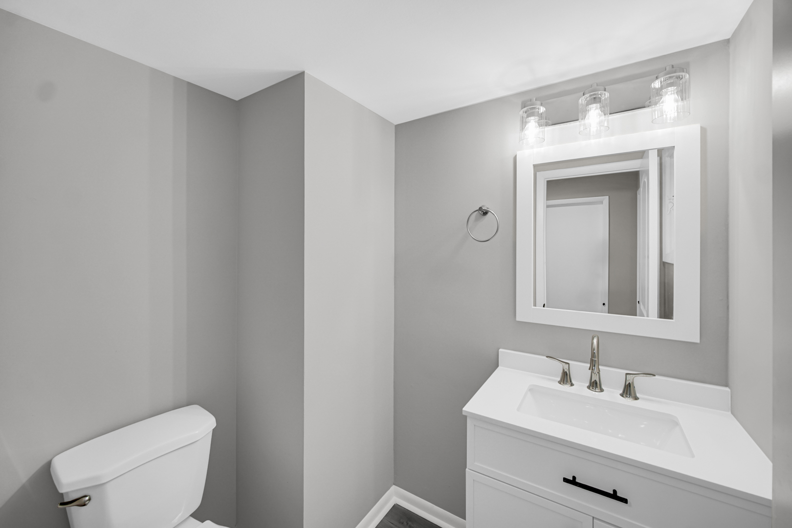 6827 Sussex Road Tinley Park, IL 60477 - Photo 10 of 27 a bathroom with a toilet sink vanity and mirror