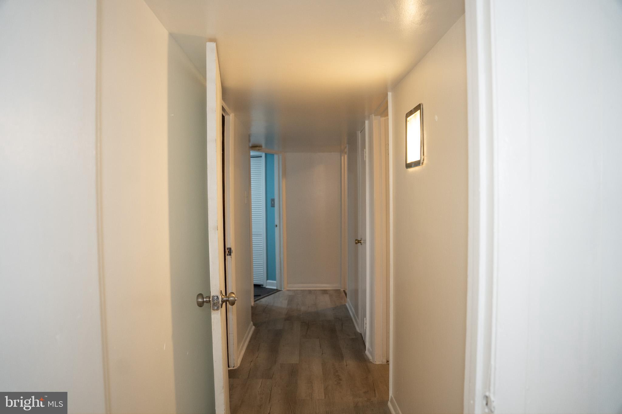 6304 Somerset Road Riverdale, MD 20737 - Photo 18 of 22 a view of a hallway with wooden floor
