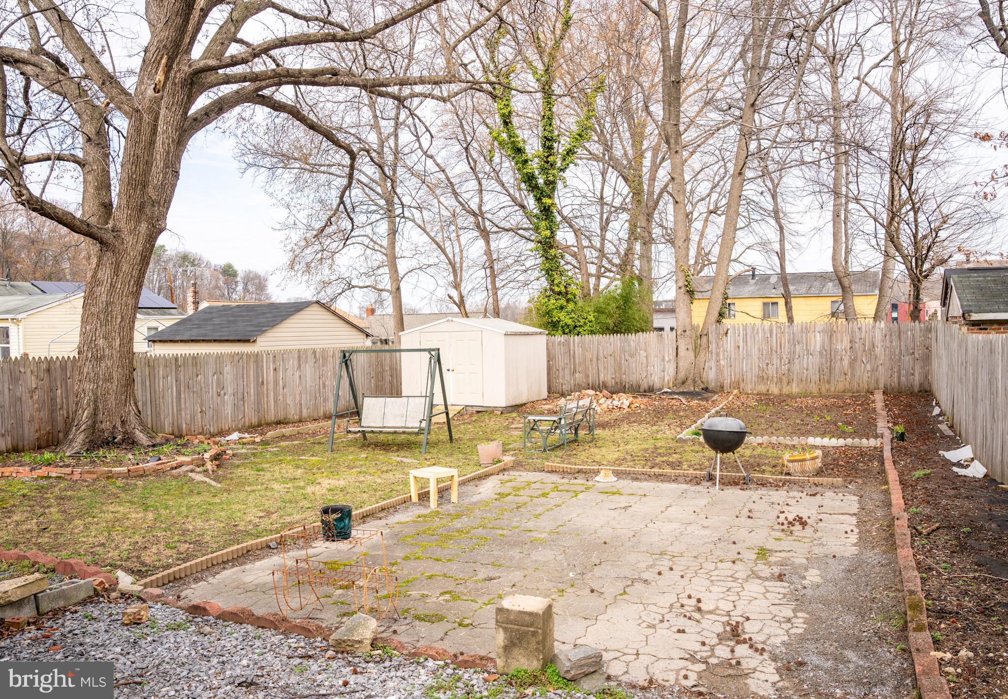 6304 Somerset Road Riverdale, MD 20737 - Photo 21 of 22 a view of backyard with wooden fence and large trees