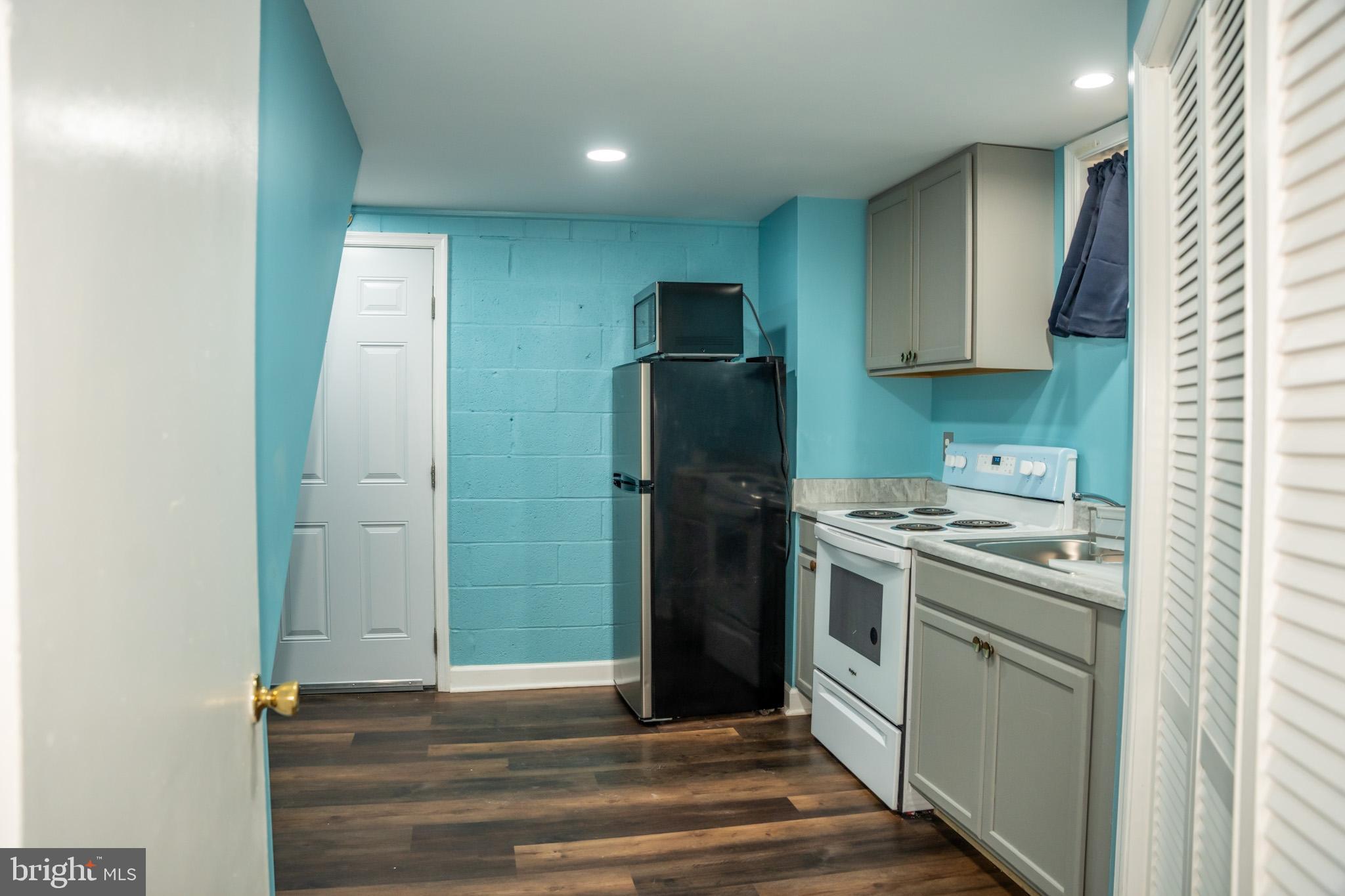6304 Somerset Road Riverdale, MD 20737 - Photo 4 of 22 a kitchen with stainless steel appliances granite countertop a refrigerator and a stove
