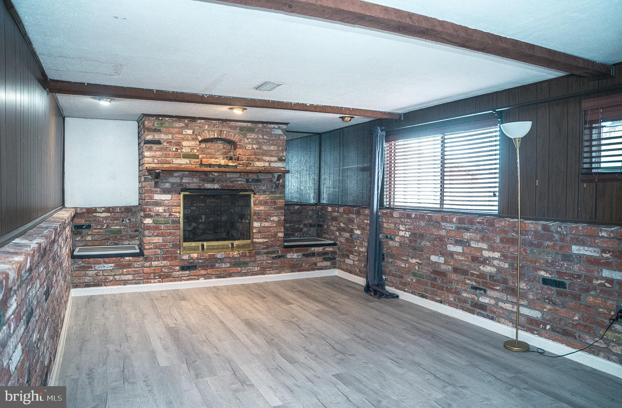 6304 Somerset Road Riverdale, MD 20737 - Photo 10 of 22 a living room with furniture and a fireplace