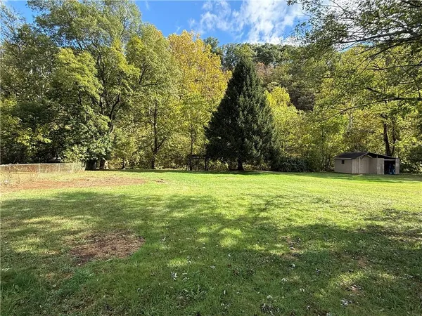 a view of outdoor space with swimming pool and green space