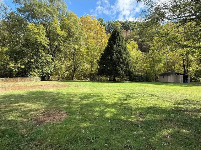 a view of outdoor space with swimming pool and green space