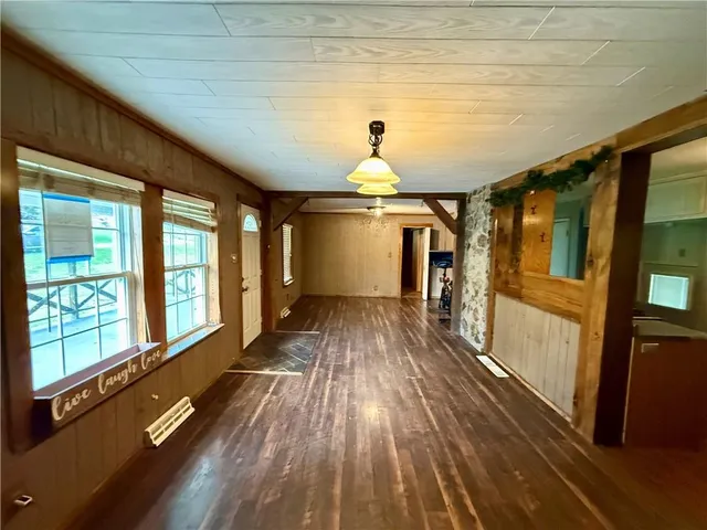 a view of a room with wooden floor