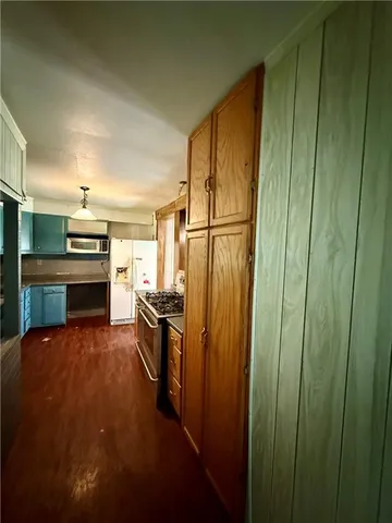 a view of wooden floor and an entryway