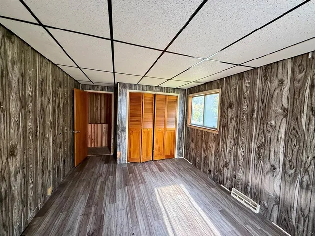 a view of a room with wooden floor and a window