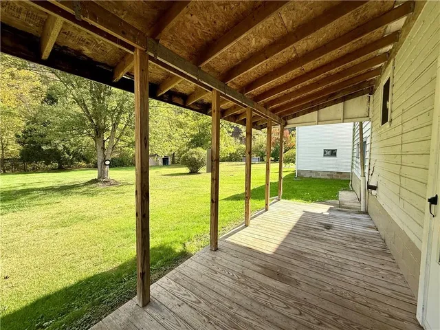 a view of house with yard and outdoor seating