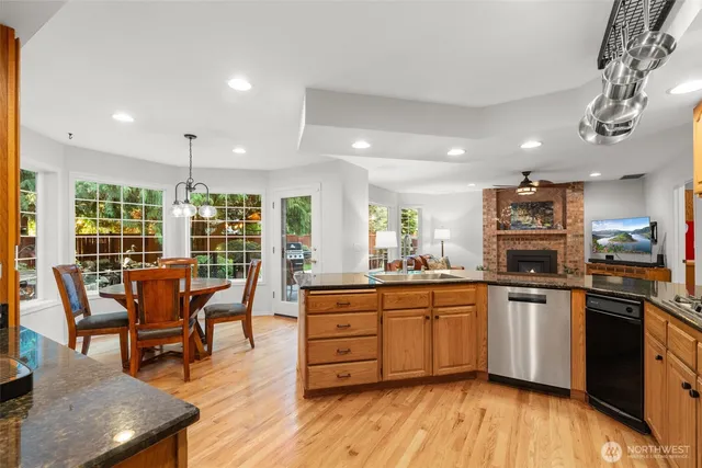 a kitchen with granite countertop a refrigerator and a stove top oven