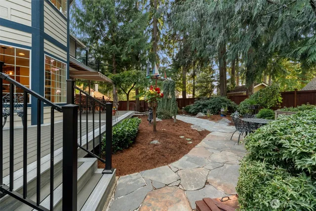 a view of a chair and table in backyard