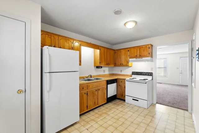 a kitchen with a stove top oven and cabinets