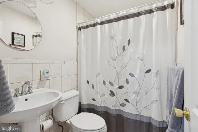 a white toilet sitting next to a bathroom sink