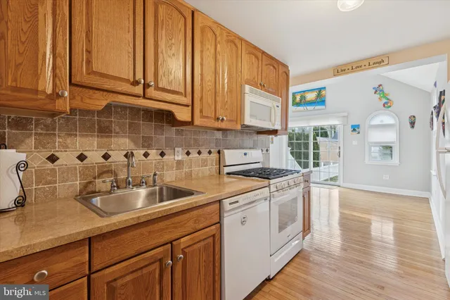 a kitchen with a sink cabinets and wooden floor