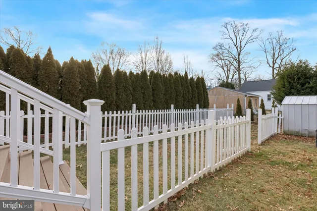 a view of a gate with wooden fence