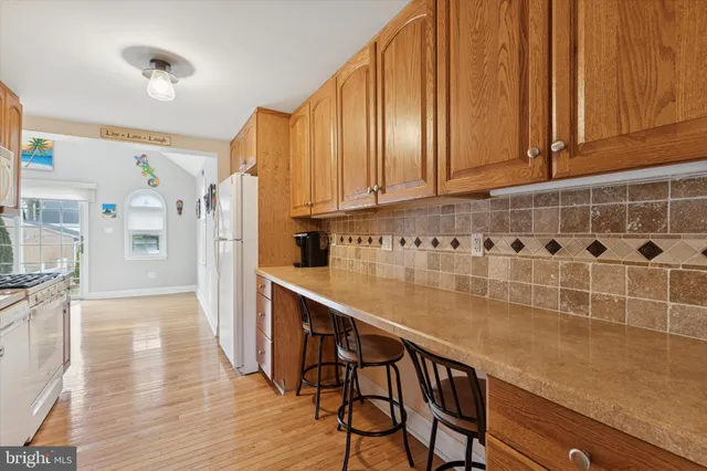 a kitchen with stainless steel appliances wooden cabinets and a refrigerator
