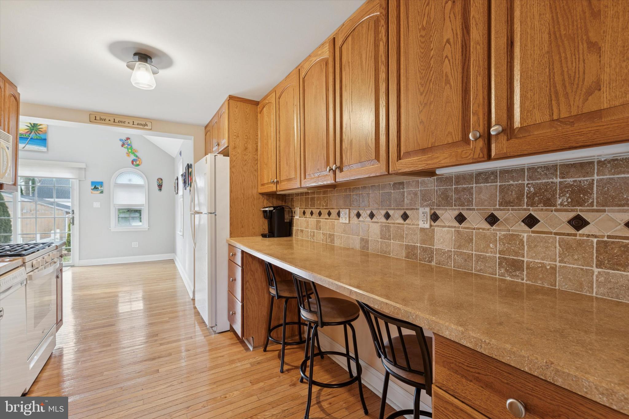 2718 Hawthorne Road Glenside, PA 19038 - Photo 3 of 23 a kitchen with stainless steel appliances wooden cabinets and a refrigerator