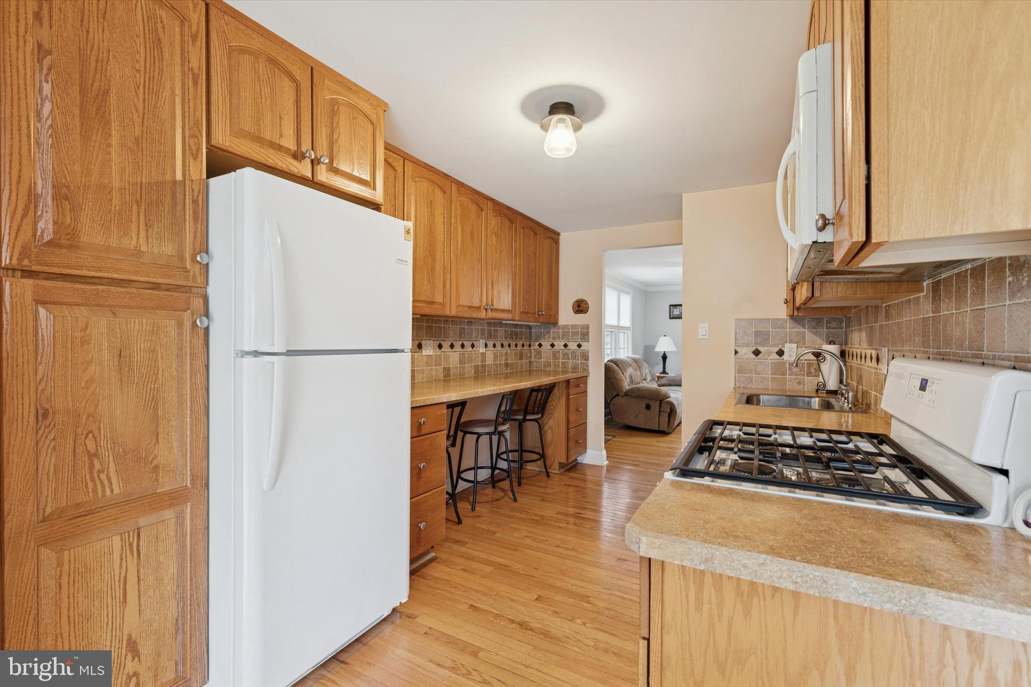 2718 Hawthorne Road Glenside, PA 19038 - Photo 4 of 23 a kitchen with a refrigerator and a stove top oven