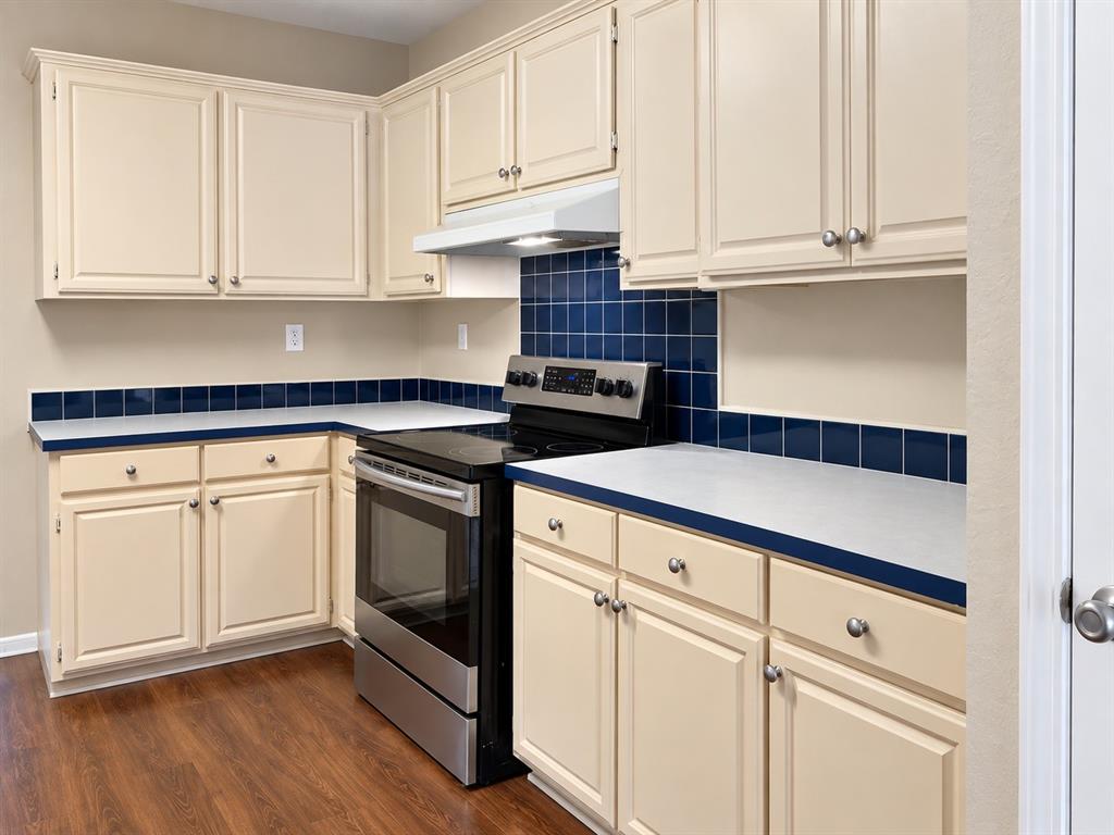 301 South Coppell Road, Unit 51 Coppell, TX 75019 - Photo 5 of 20 Wood-finish flooring with a full suite of stainless steel appliances