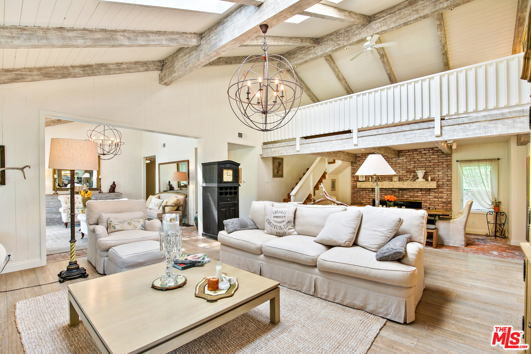6133 Ramirez Canyon Road Malibu, CA 90265 - Photo 1 of 53 a living room with furniture and wooden floor