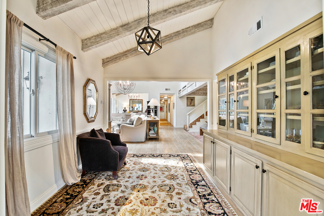6133 Ramirez Canyon Road Malibu, CA 90265 - Photo 12 of 53 a living room with furniture a rug and a window