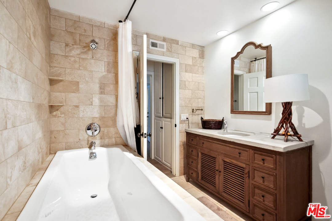6133 Ramirez Canyon Road Malibu, CA 90265 - Photo 32 of 53 a bathroom with a sink and a large mirror