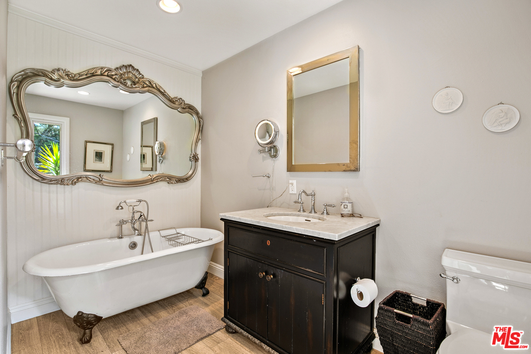 6133 Ramirez Canyon Road Malibu, CA 90265 - Photo 34 of 53 a bathroom with a toilet sink and mirror