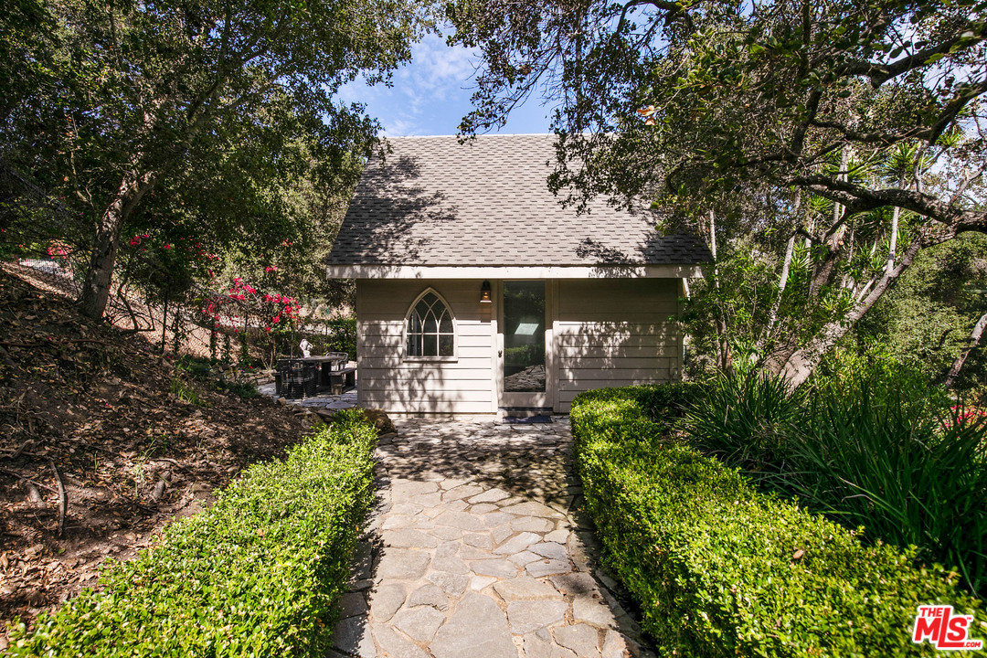 6133 Ramirez Canyon Road Malibu, CA 90265 - Photo 41 of 53 a front view of a house with a yard