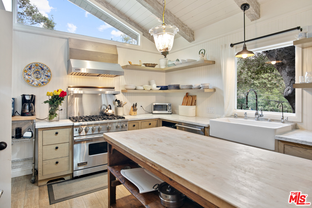 6133 Ramirez Canyon Road Malibu, CA 90265 - Photo 7 of 53 a kitchen with stainless steel appliances granite countertop a stove and a refrigerator