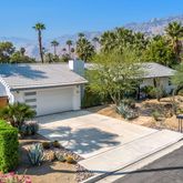 a view of a patio with table and chairs potted plants