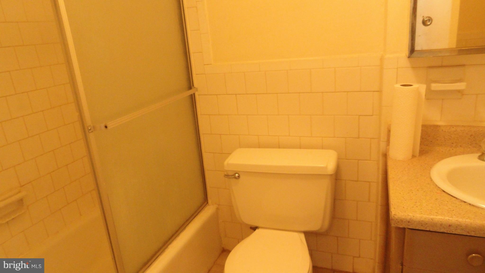 1911 Addison Road South District Heights, MD 20747 - Photo 11 of 15 a bathroom with a toilet and a shower