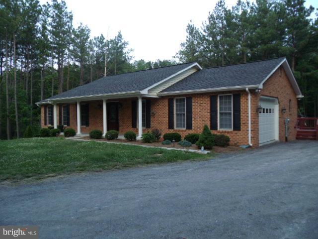 20140 Fort Valley Road Strasburg, VA 22657 - Photo 11 of 25 a view of a yard in front of a house with large windows