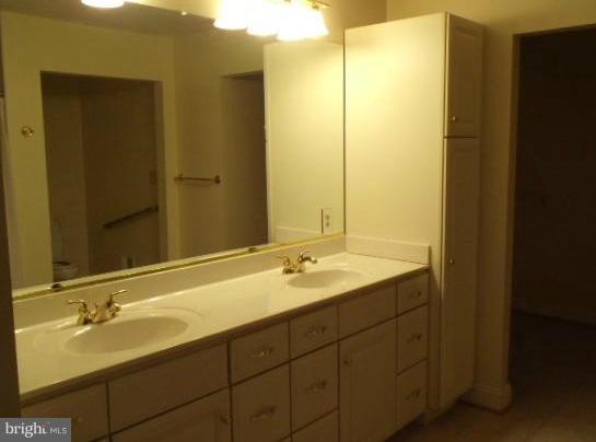 20140 Fort Valley Road Strasburg, VA 22657 - Photo 16 of 25 a bathroom with a double vanity sink and a mirror