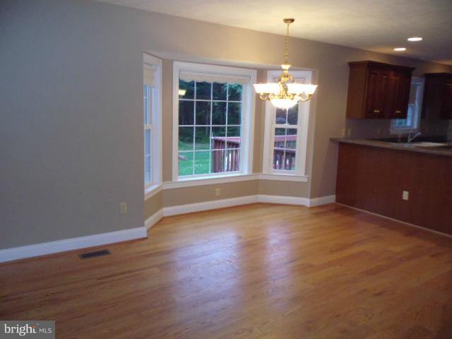 20140 Fort Valley Road Strasburg, VA 22657 - Photo 7 of 25 a view of an empty room with wooden floor and a window