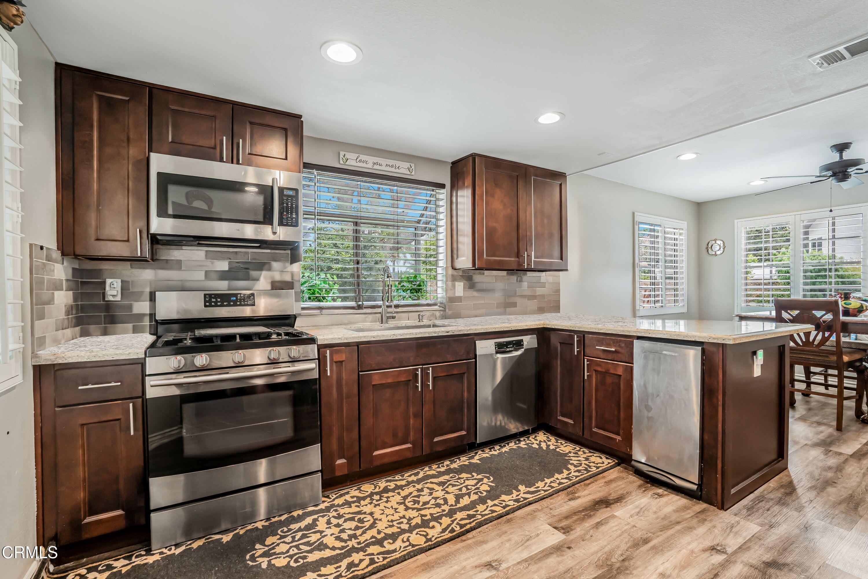 2752 Lemon Drive Simi Valley, CA 93063 - Photo 11 of 31 a kitchen with stainless steel appliances granite countertop a stove microwave and sink