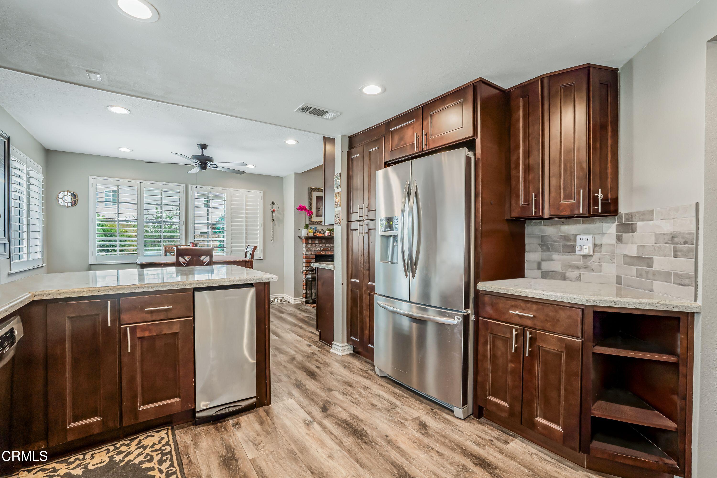 2752 Lemon Drive Simi Valley, CA 93063 - Photo 13 of 31 a kitchen with stainless steel appliances granite countertop a refrigerator a sink dishwasher and wooden cabinets with wooden floor