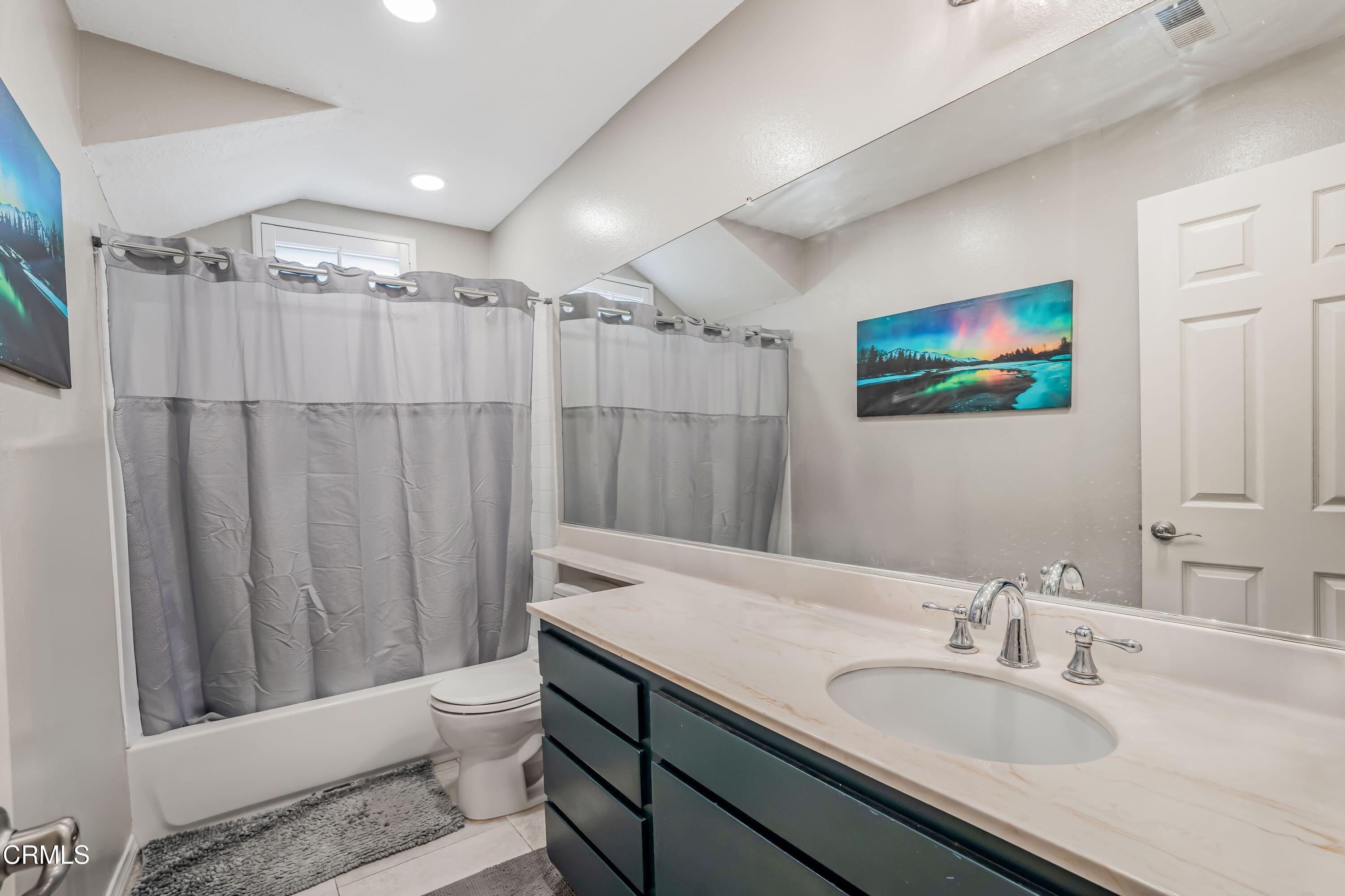 2752 Lemon Drive Simi Valley, CA 93063 - Photo 18 of 31 a bathroom with a granite countertop sink a toilet a mirror and shower