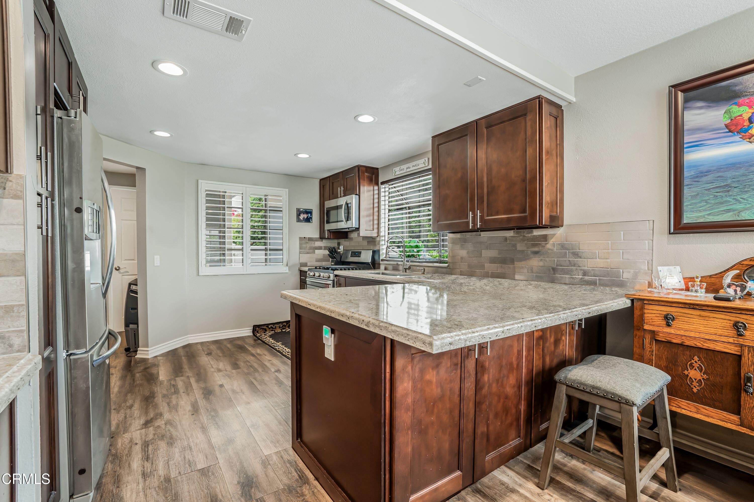 2752 Lemon Drive Simi Valley, CA 93063 - Photo 10 of 31 a kitchen with a stove a sink and a refrigerator
