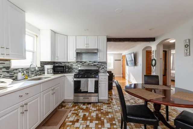 a kitchen with stainless steel appliances kitchen island granite countertop a sink and cabinets