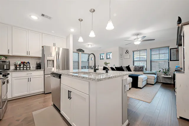 a kitchen with counter top space appliances and cabinets