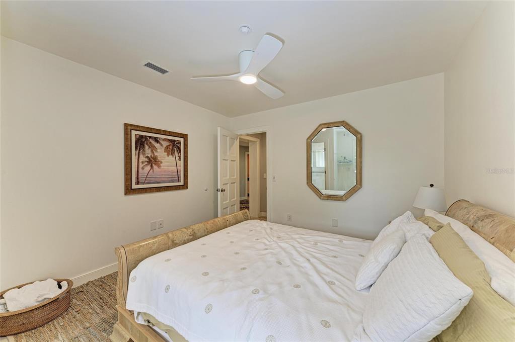 4473 Gulf Of Mexico Drive, Unit 4473 Longboat Key, FL 34228 - Photo 14 of 50 a bedroom with a bed and a mirror
