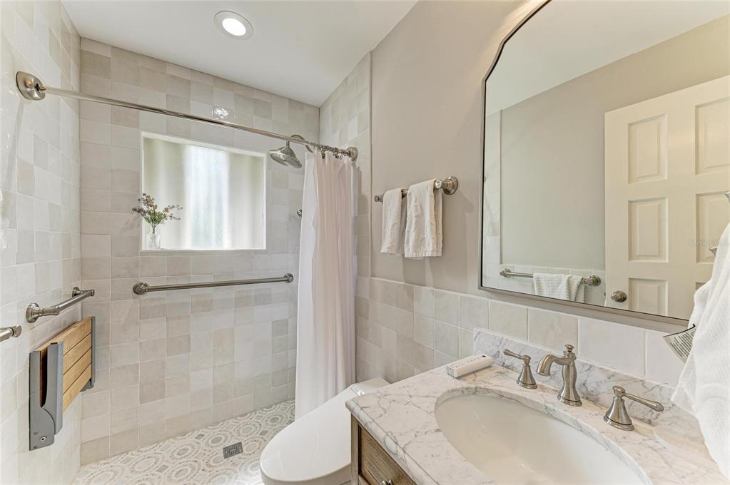 4473 Gulf Of Mexico Drive, Unit 4473 Longboat Key, FL 34228 - Photo 19 of 50 a bathroom with a sink toilet and shower