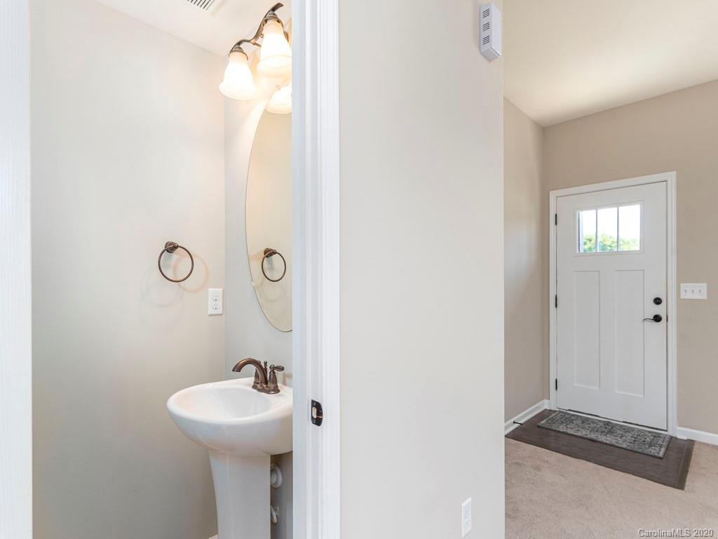 189 North River Road Fletcher, NC 28732 - Photo 5 of 27 a bathroom with a sink and mirror with toilet