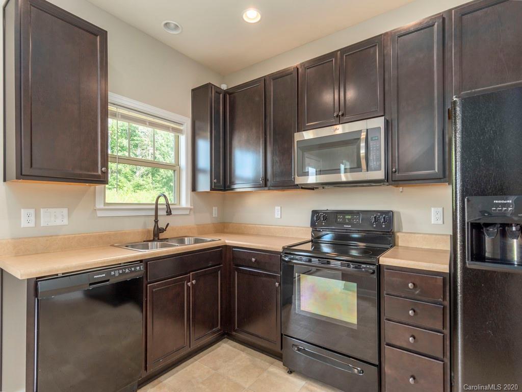 189 North River Road Fletcher, NC 28732 - Photo 9 of 27 a kitchen with kitchen island granite countertop stainless steel appliances a stove sink and microwave